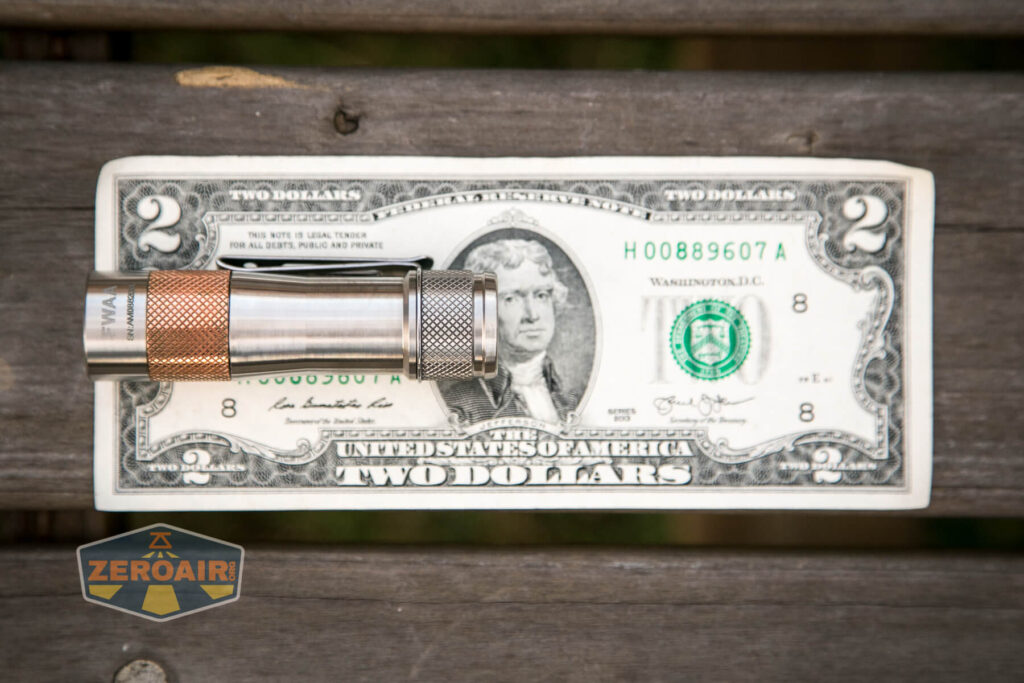 Lumintop FWAA TiCU 14500 flashlight on two-dollar bill