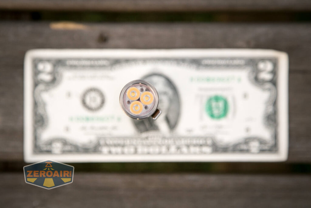 Lumintop FWAA TiCU 14500 flashlight on two-dollar bill