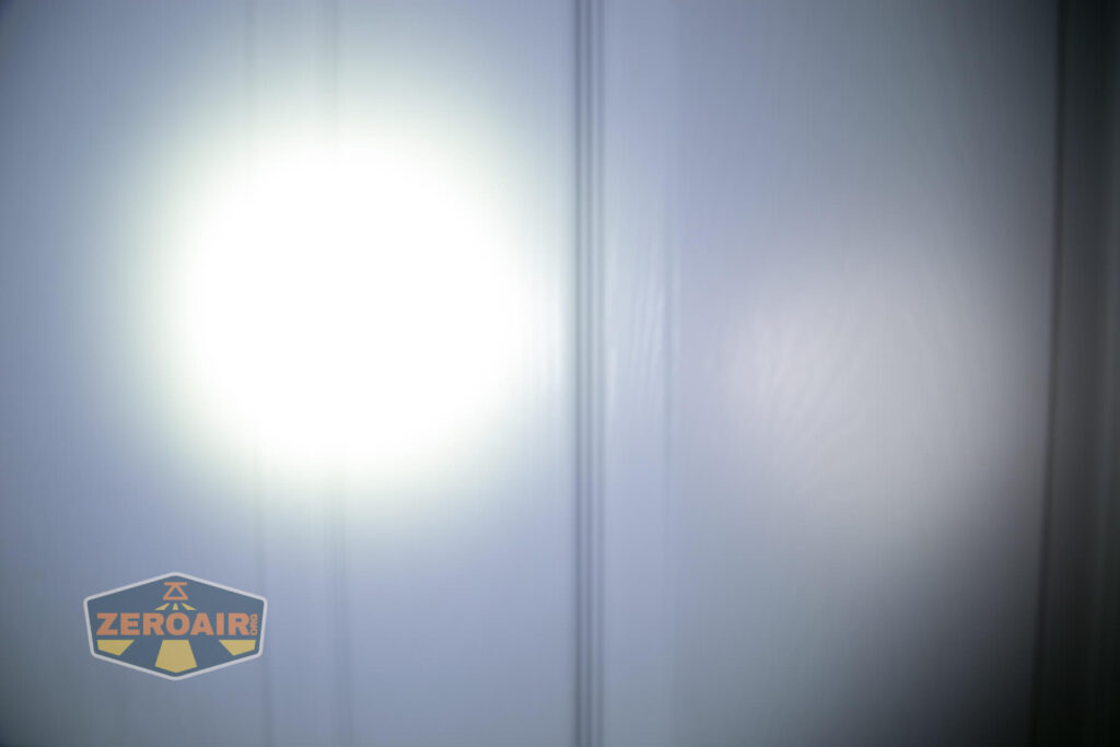 Nicron H15 Headlamp beamshots on door compared to nichia 219b