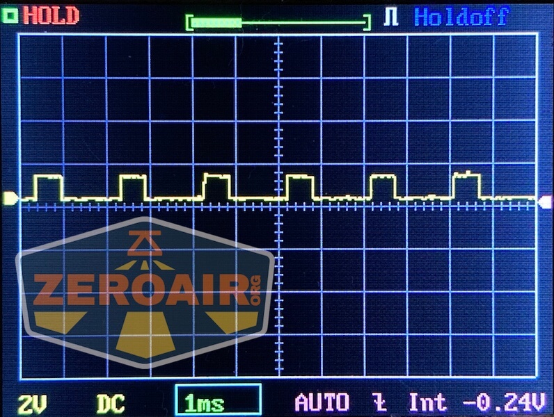 A digital oscilloscope screen displays a square wave signal. The axis is labeled 1ms and 2V DC, with -0.24V at the bottom. The WWLZ Bamboo Small logo, along with ZeroAir, partially covers the display.