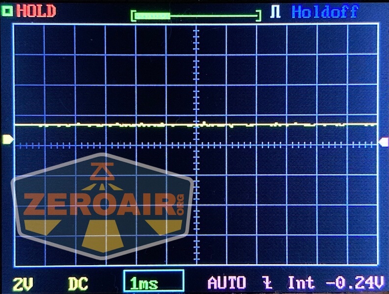 An oscilloscope screen shows a nearly flat yellow waveform near the center. The display reads 2V/div, 1ms/div, -0.24V mean value, and features a large WWLZ Bamboo Small ZeroAir logo watermark.