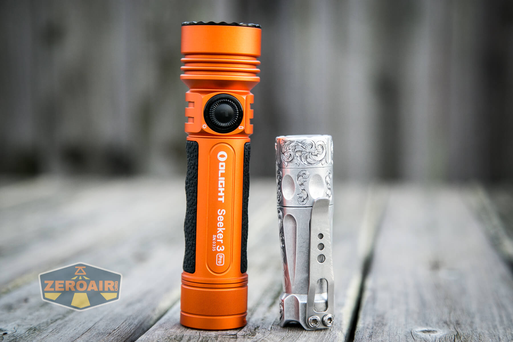 Olight Seeker 3 Pro beside torchlab boss 35