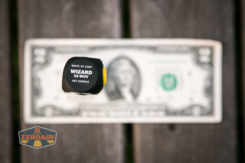 Armytek Wizard C2 WUV Headlamp on two-dollar bill
