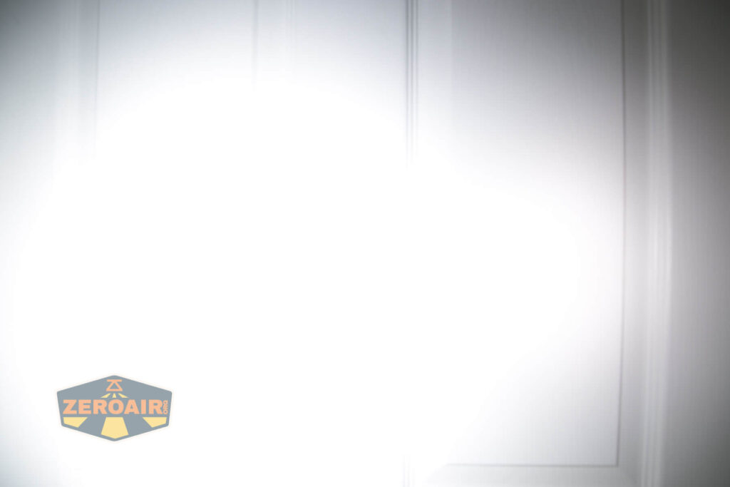 Armytek Wizard C2 WUV Headlamp beamshot on door compared to nichia 219b