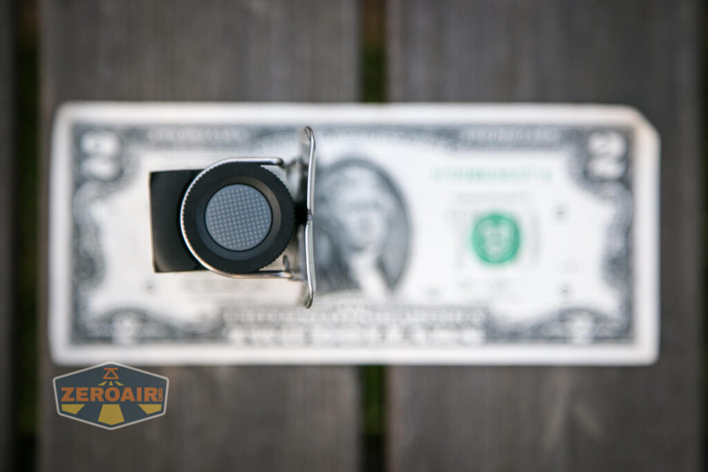 Cyansky HS6R headlamp on two-dollar bill