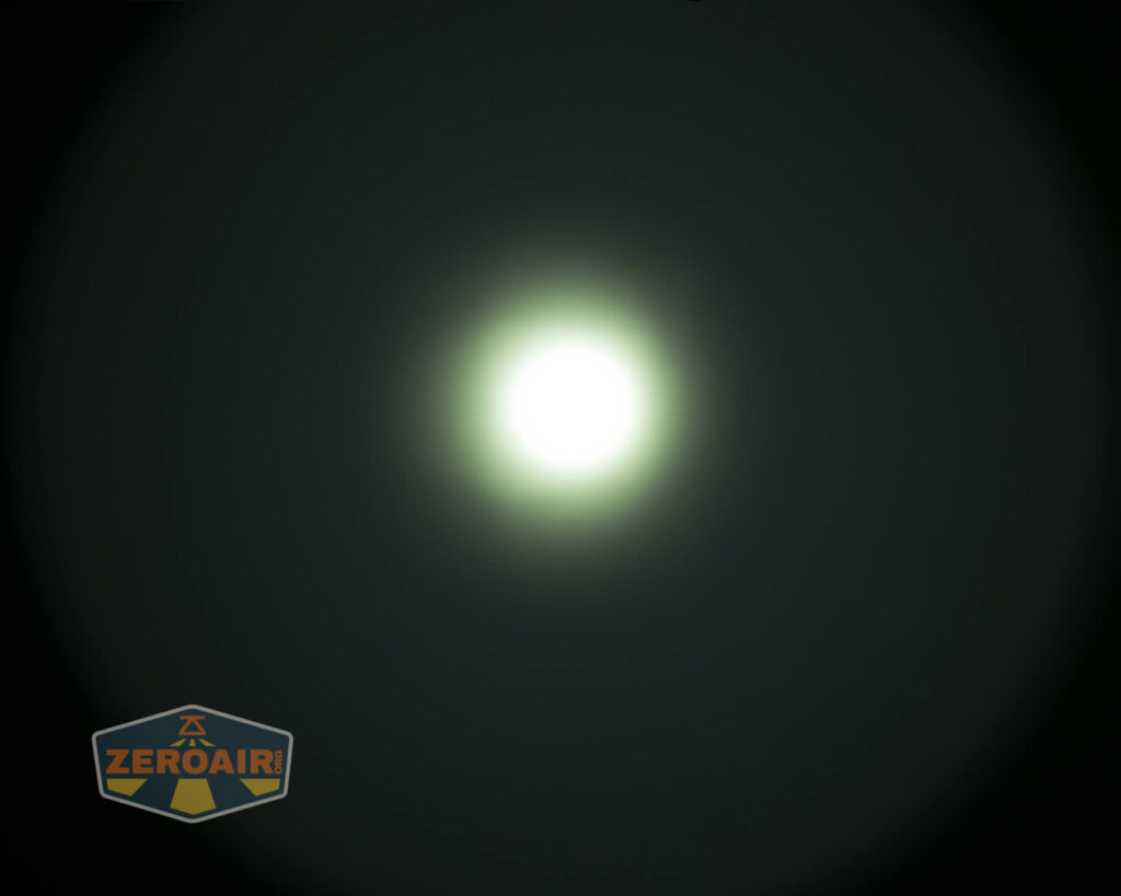A bright white light with a greenish halo in the center of a dark background. The ZeroAir logo is in the bottom left corner.