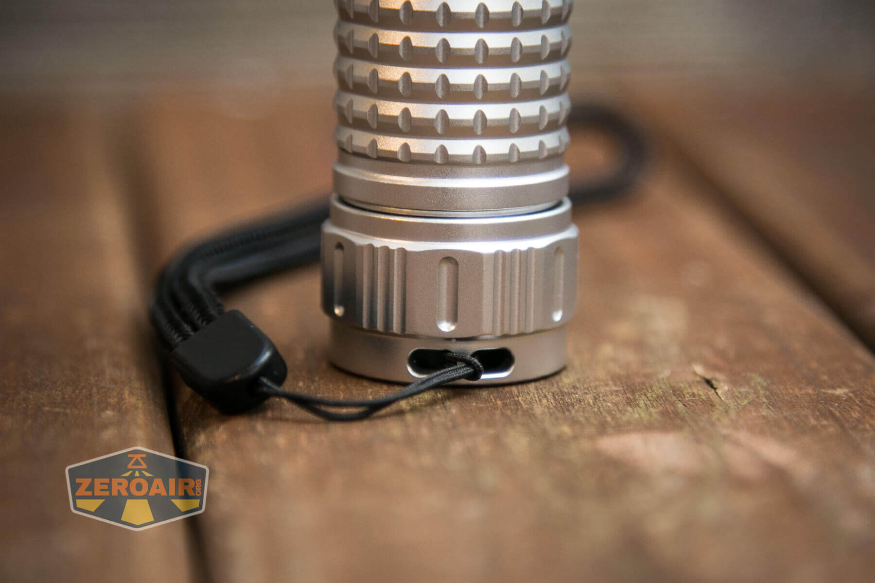Convoy M21E Flashlight tailstanding with lanyard
