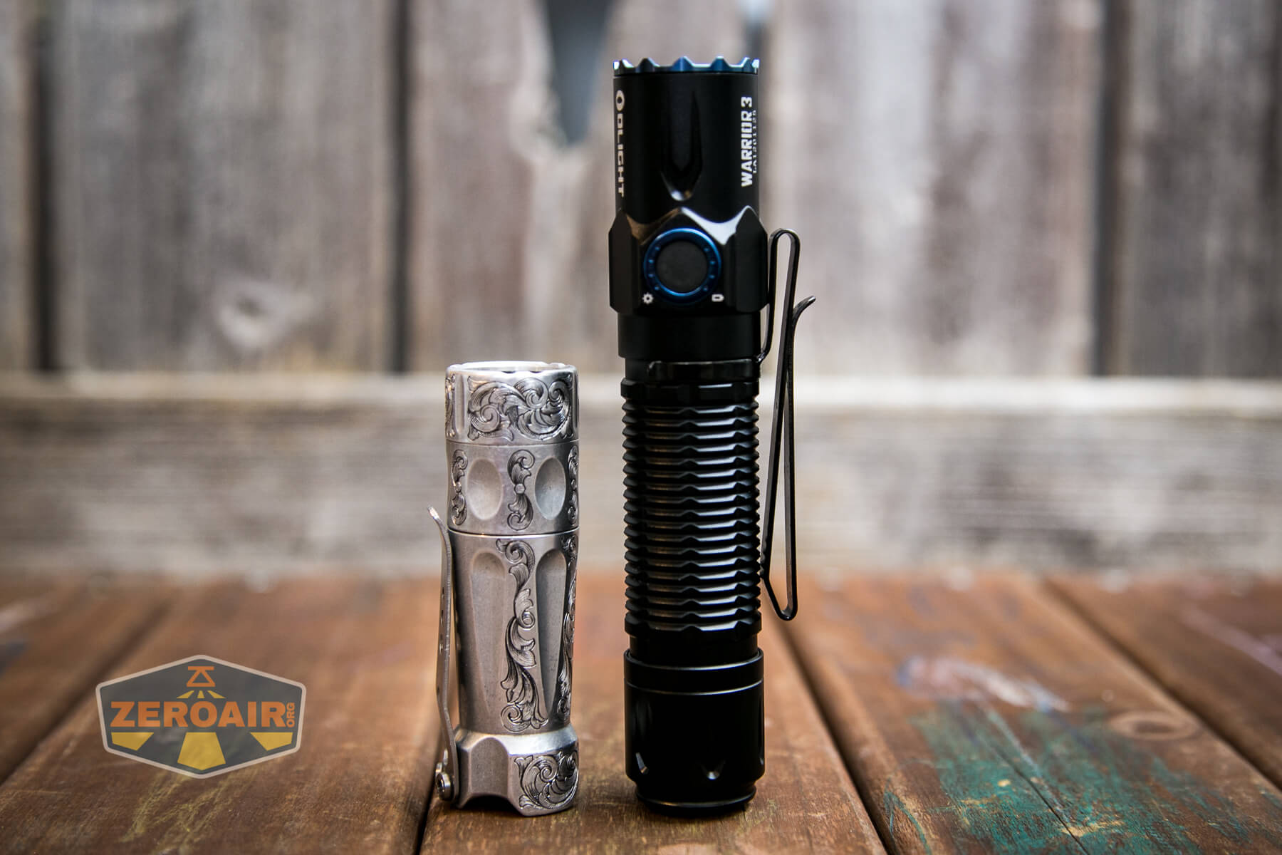 Olight Warrior 3 flashlight beside torchlab boss 35