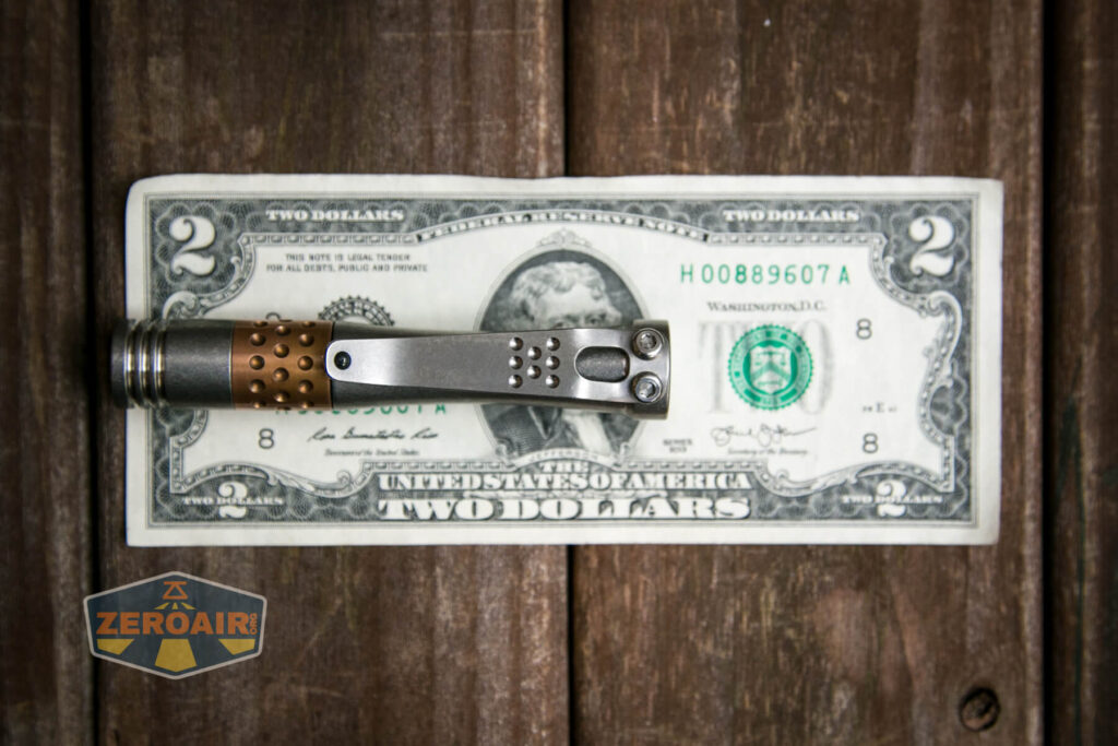 Laulima Metal Craft Hoku flashlight on two-dollar bill