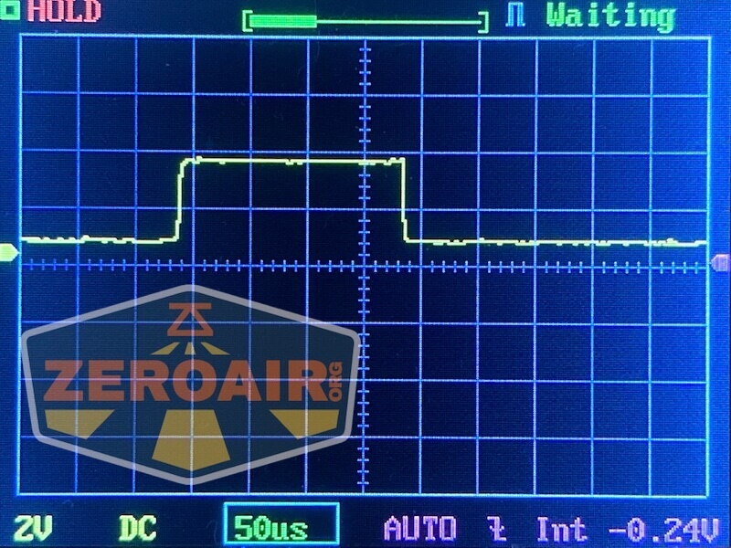 A digital oscilloscope screen displays a square wave signal with clear rising and falling edges. The settings read 2V, DC, 50µs per division, and AUTO mode. The ZeroAir.net logo is visible in the lower left corner.