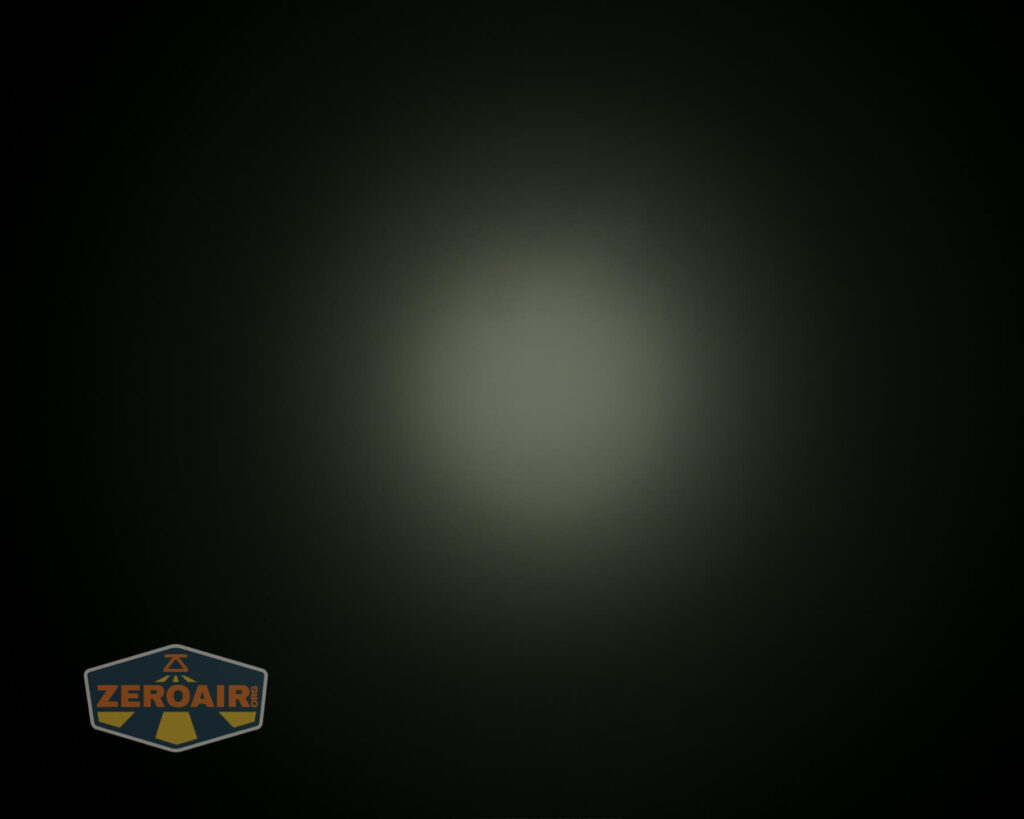 A dim, circular white light is centered on a dark background. The logo ZeroAir is visible in the bottom left corner.