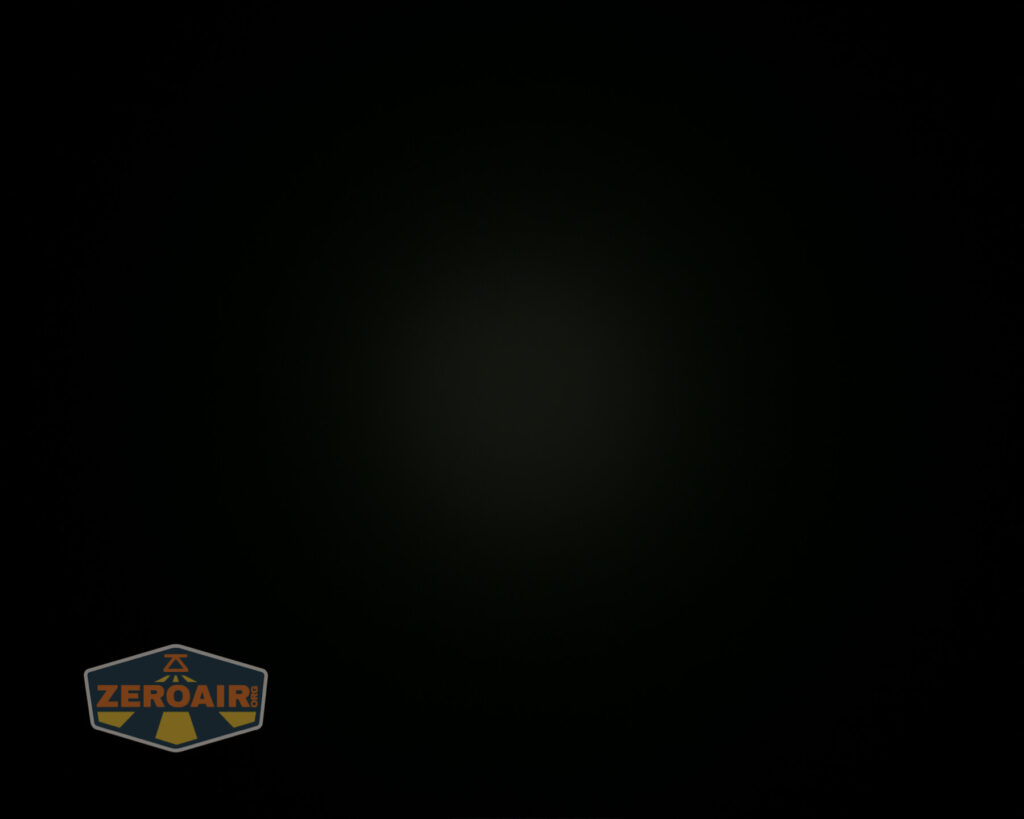 Mostly black image with a faint, barely visible light spot in the center. The lower left corner displays a ZeroAir logo with orange and grey colors.