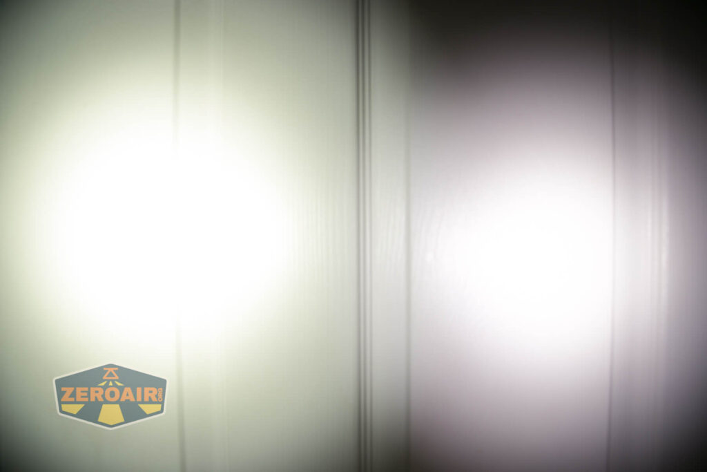 Two flashlight beams are projected onto a white wall, creating two circular spots with different color temperatures. The logo ZEROAIR is visible in the lower left corner of the image.