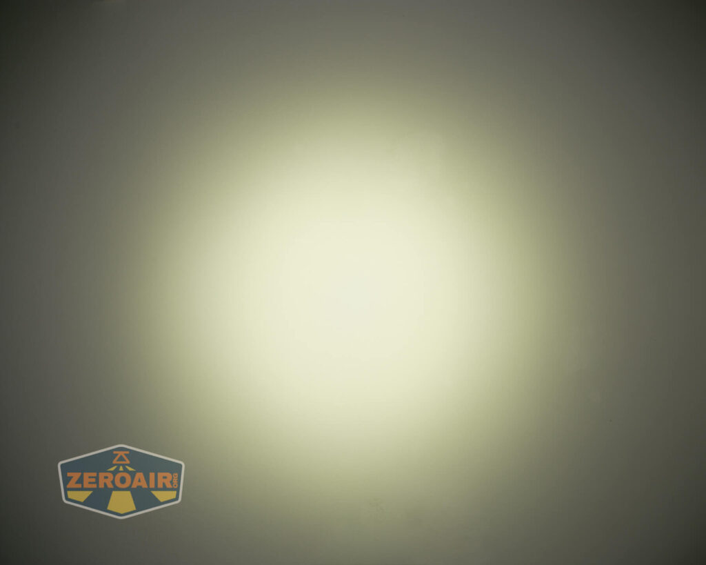 A circular beam of yellowish-white light is centered on a dark background, creating a gradient effect. A logo with the text ZeroAir is visible in the bottom left corner.