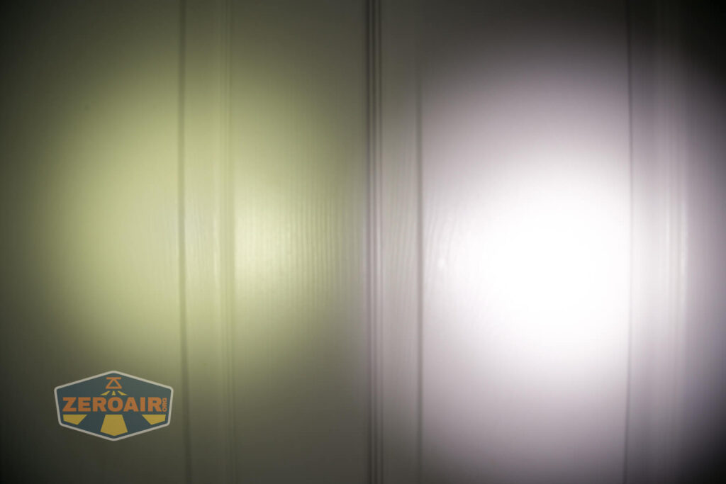 Two flashlight beams are projected onto a white, paneled wall. The left beam has a yellowish tint, while the right beam is cooler and white. A ZeroAir logo appears in the bottom left corner of the image.