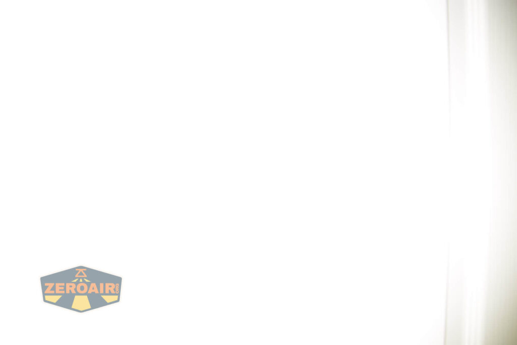 A mostly white image with a faint shadowed border on the right side and a small hexagonal logo labeled ZEROAIR in yellow and gray in the bottom left corner.