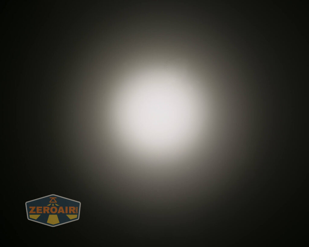 A bright white light source is centered against a dark background, creating a gradient halo effect. The ZeroAir logo is visible in the lower left corner of the image.