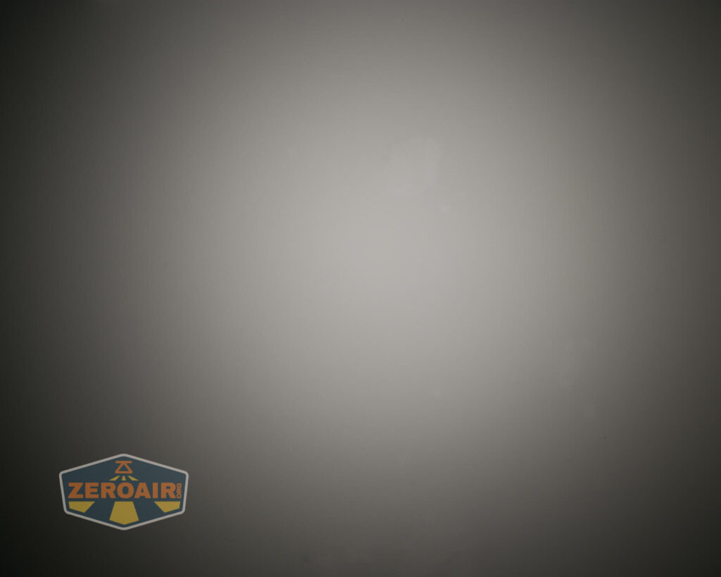 A plain, gradient gray background with a ZeroAir logo in the bottom left corner. The logo features stylized text and a shield design.