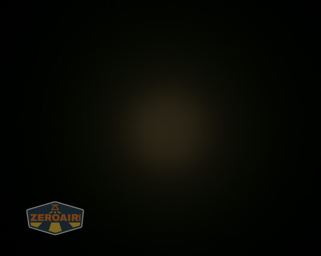 A mostly black image with a faint, dim circle of light in the center and a ZeroAir logo in the bottom left corner.