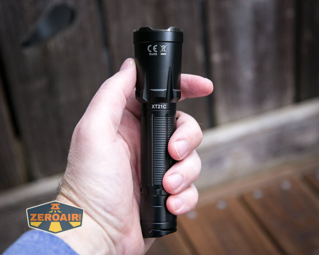 Klarus XT21C tactical flashlight in hand