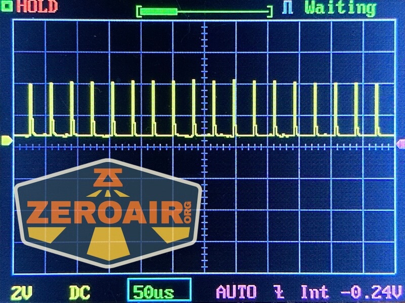 Oscilloscope display showing a repeating square wave signal with a “ZEROAIR.org” logo partially covering the lower left corner. Settings indicate 2V/div, 50 µs/div, DC coupling, and a -0.24V offset.