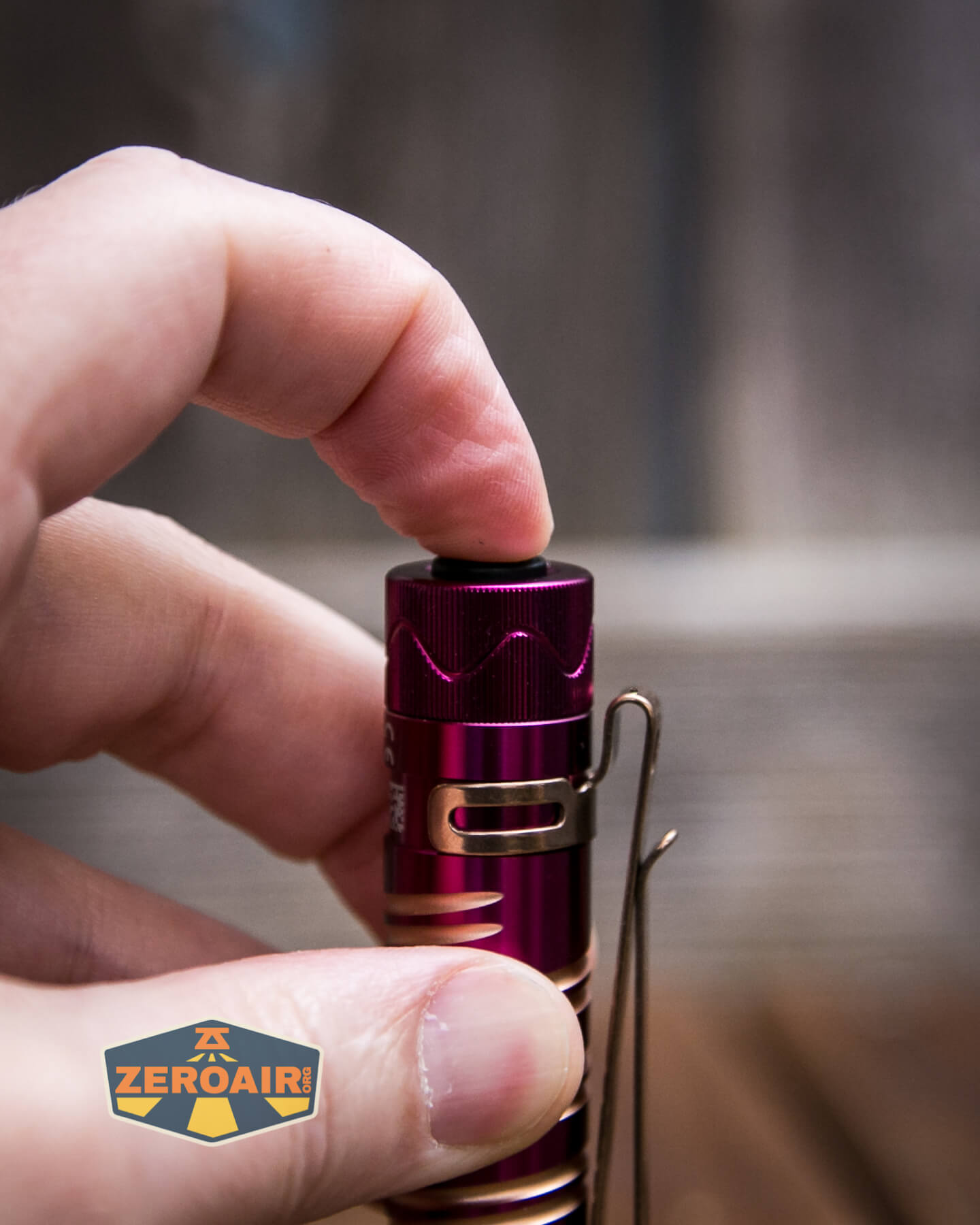 Olight i5R EOS Plum flashlight tailcap switch actuation