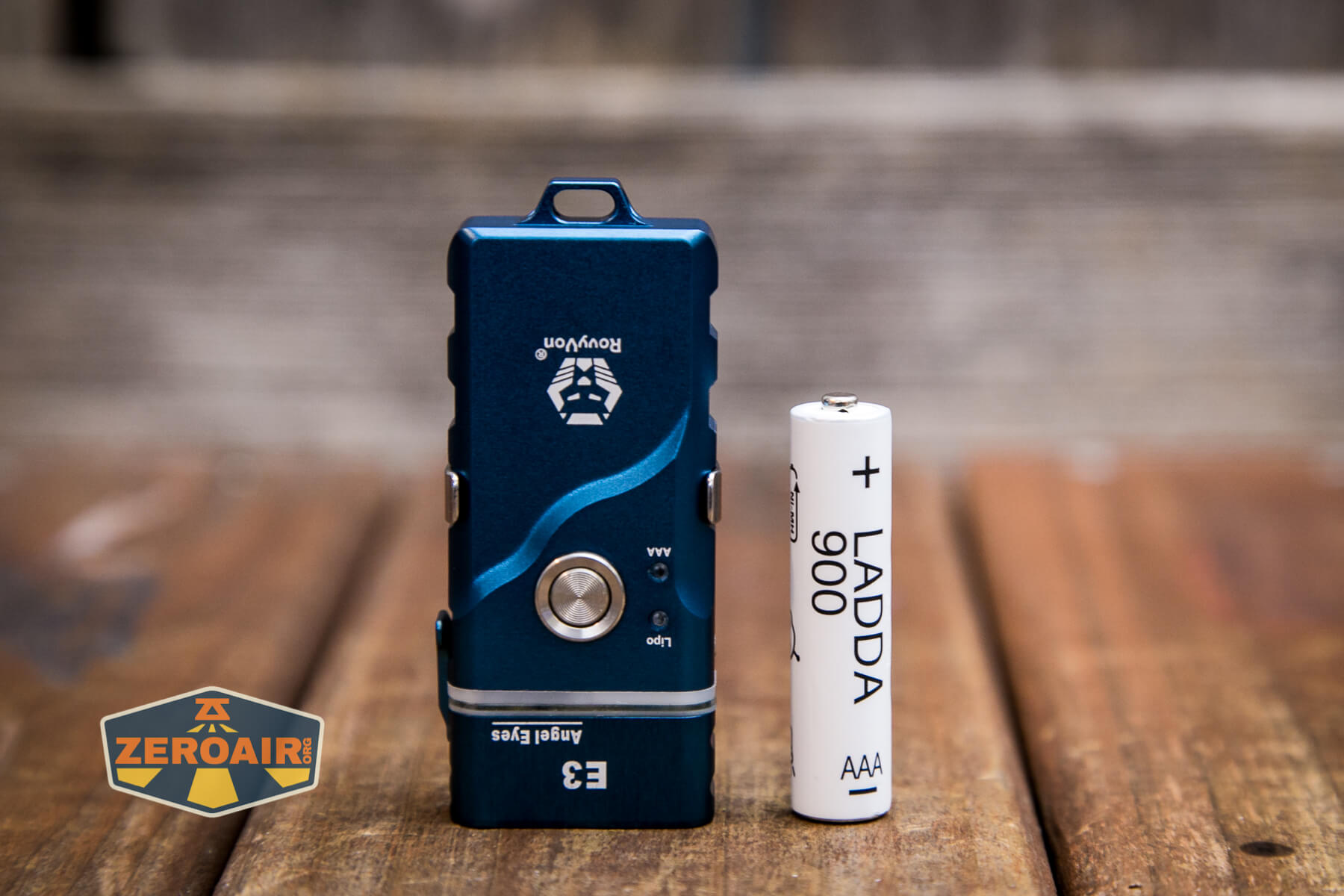RovyVon Angel Eyes E3 flashlight beside AAA cell