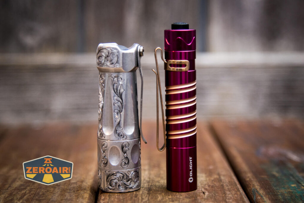 Olight i5R EOS Plum flashlight beside torchlab boss 35