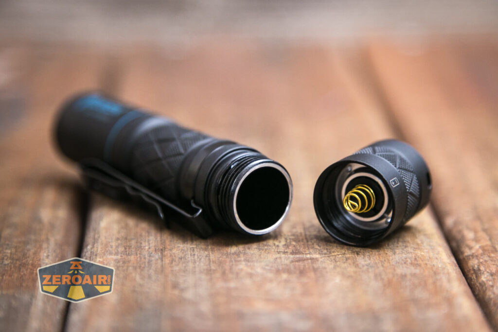 Wuben E18 flashlight tailcap off showing spring