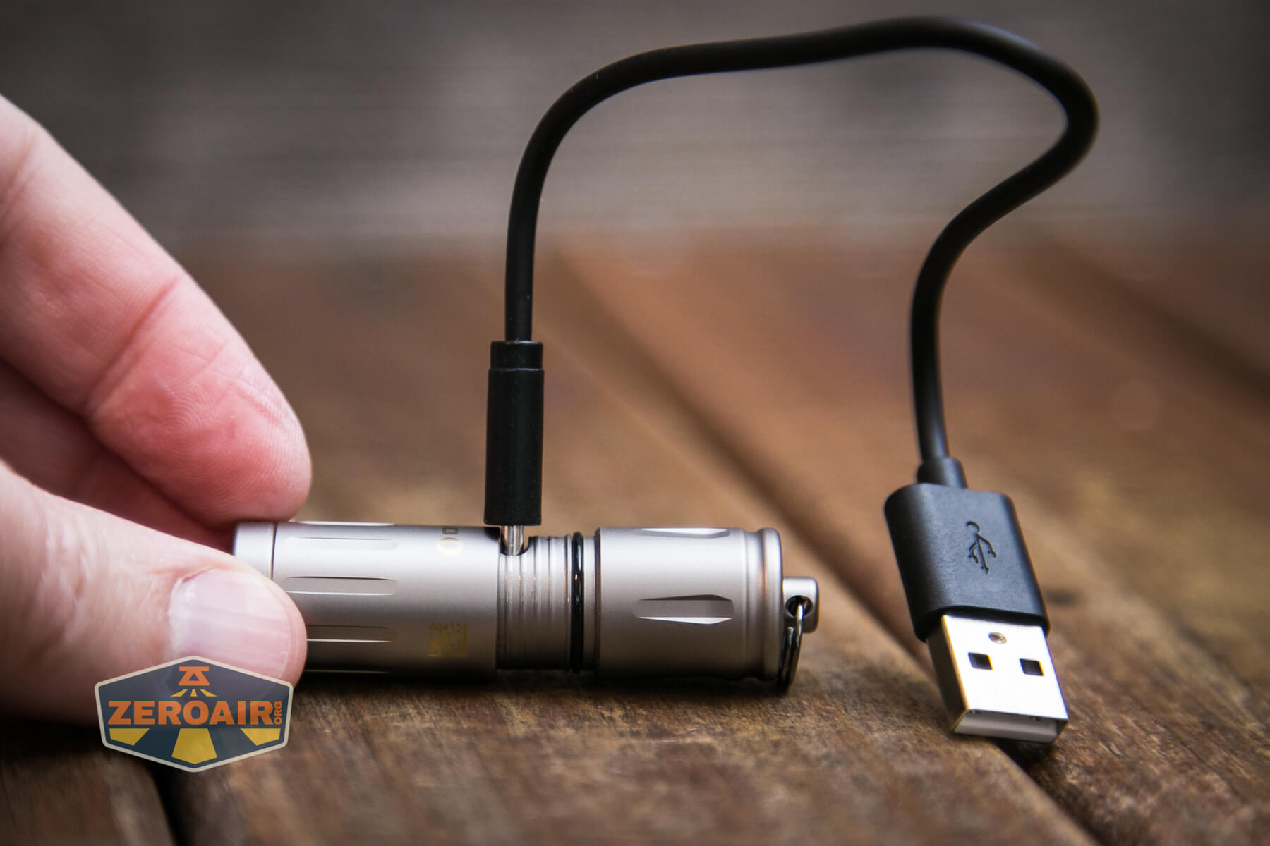 Olight iXV Ti keychain flashlight charging cable attached
