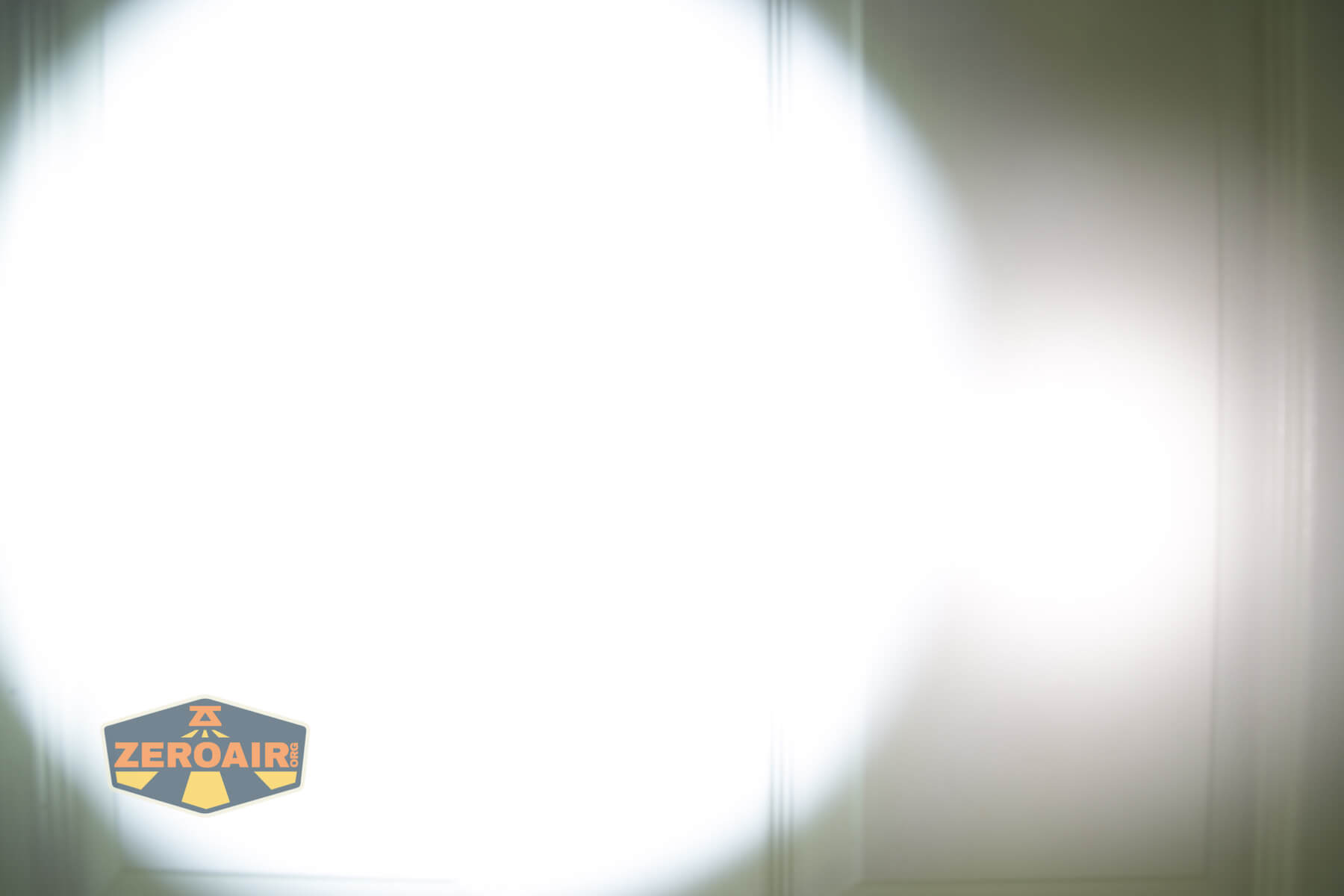 Thrunite TW20 flashlight beamshots on door compared to nichia 219b