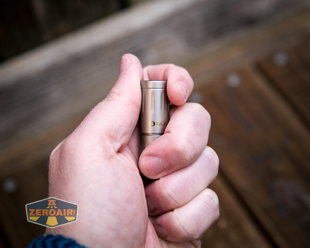 Olight iXV Ti keychain flashlight in hand