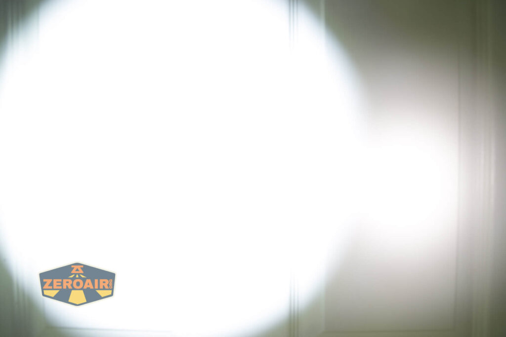 Thrunite TW20 flashlight beamshots on door compared to nichia 219b