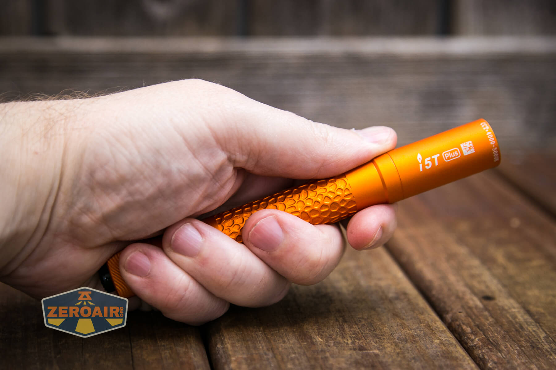 Olight i5T Plus Pebble flashlight in hand