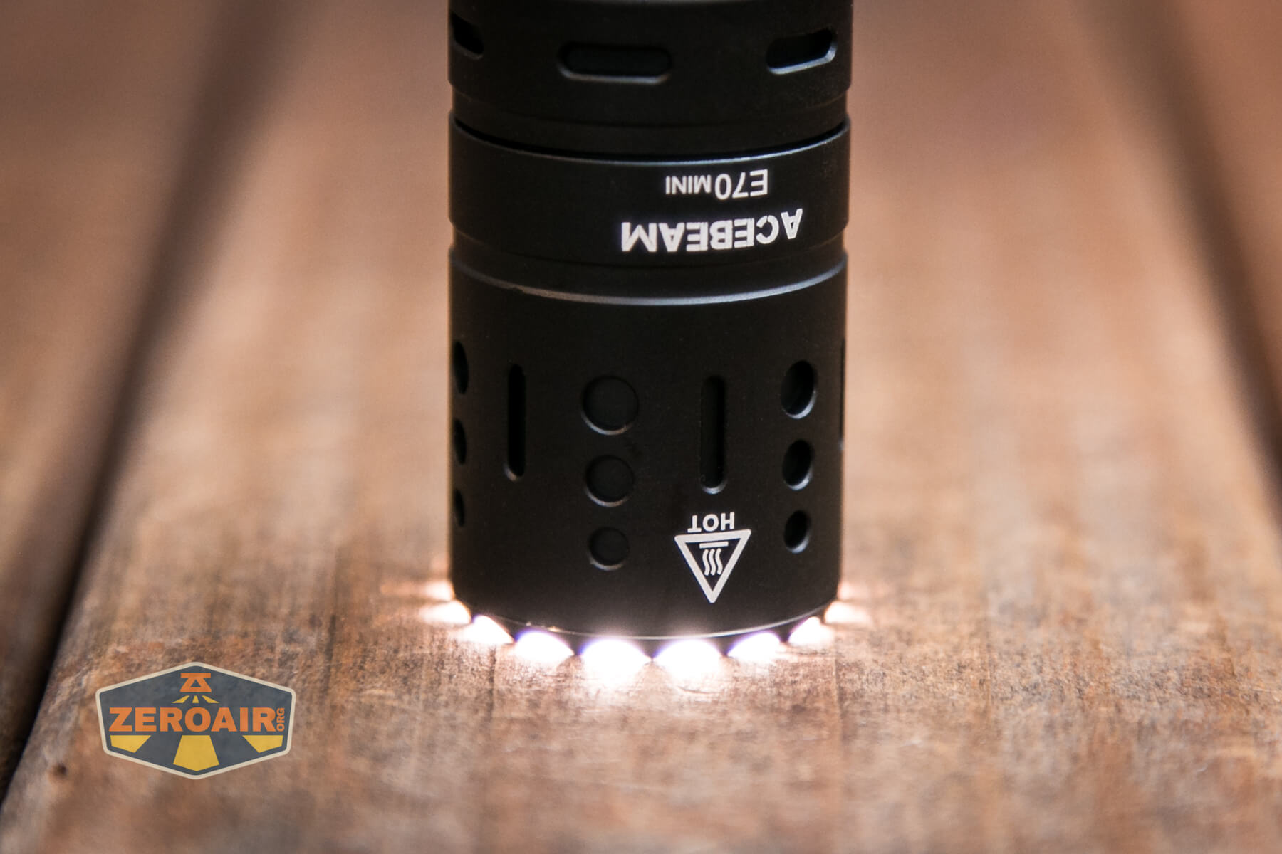 Acebeam E70 Mini flashlight headstanding on bezel