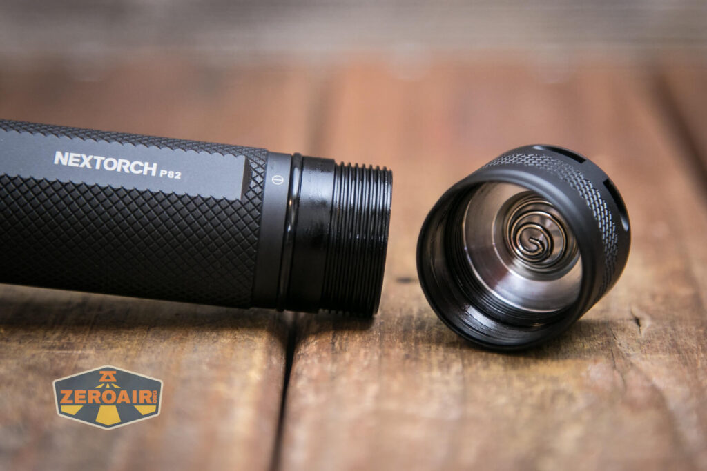Nextorch P82 long-range flashlight tailcap off showing threads and spring