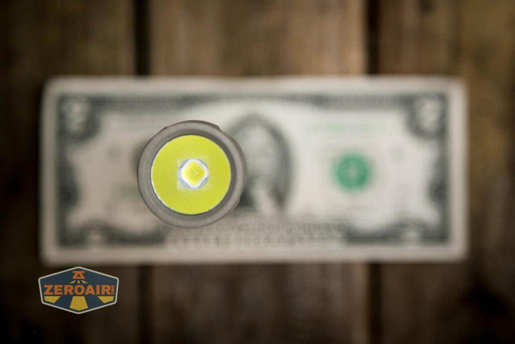 Cyansky P25 V2 flashlight on two dollar bill