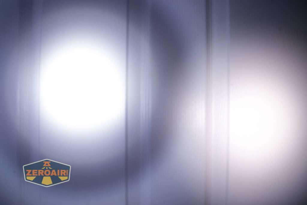 Klarus A2 Pro Zoomable flashlight beamshots on door compared to nichia 219b