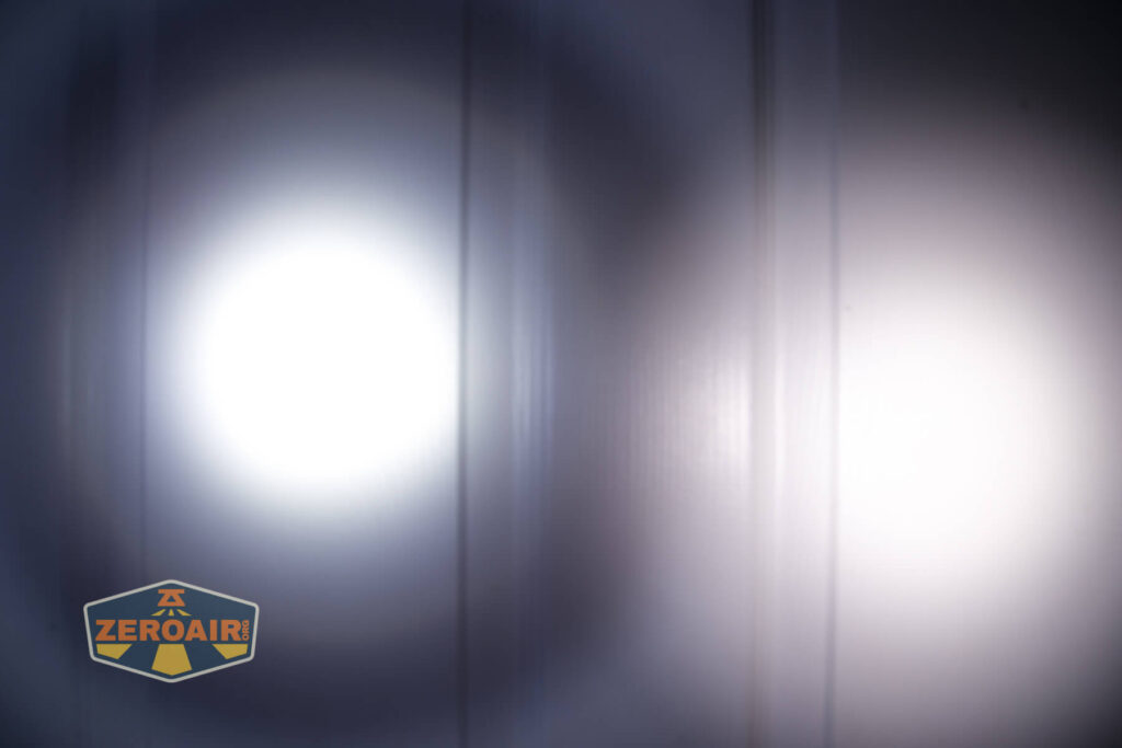 Klarus A2 Pro Zoomable flashlight beamshots on door compared to nichia 219b