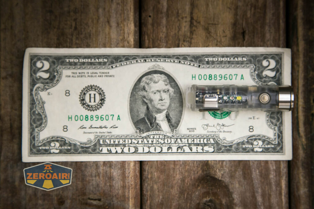RovyVon A8U keychain flashlight on a two dollar bill