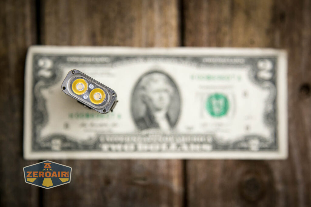 RovyVon Angel Eyes E4Ti flashlight on two dollar bill