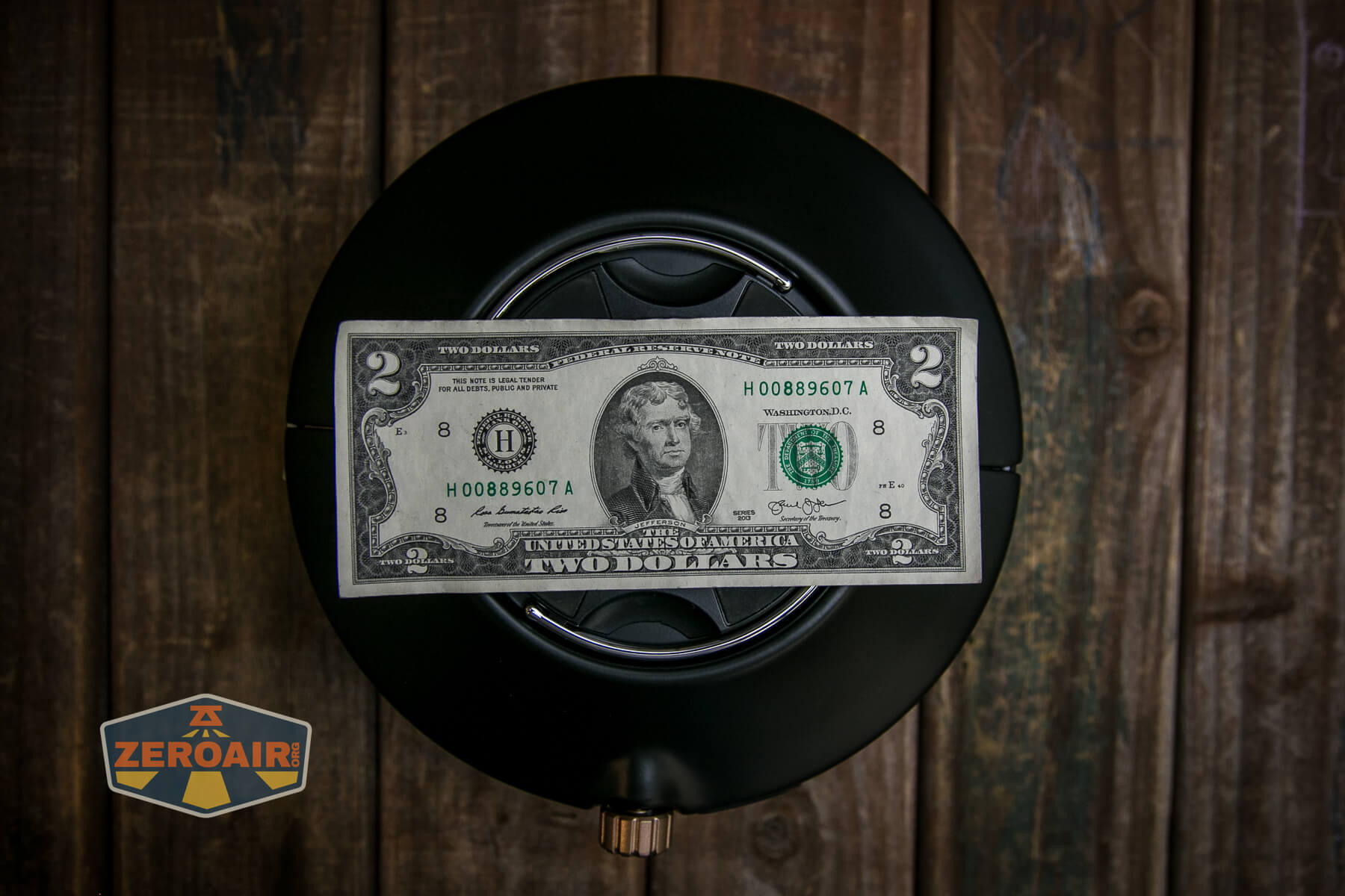 Olight Haloop camping lantern with two dollar bill