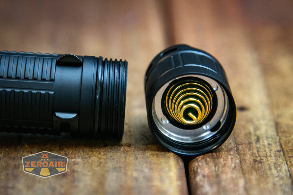 Cyansky K3 V2 flashlight tailcap removed showing spring