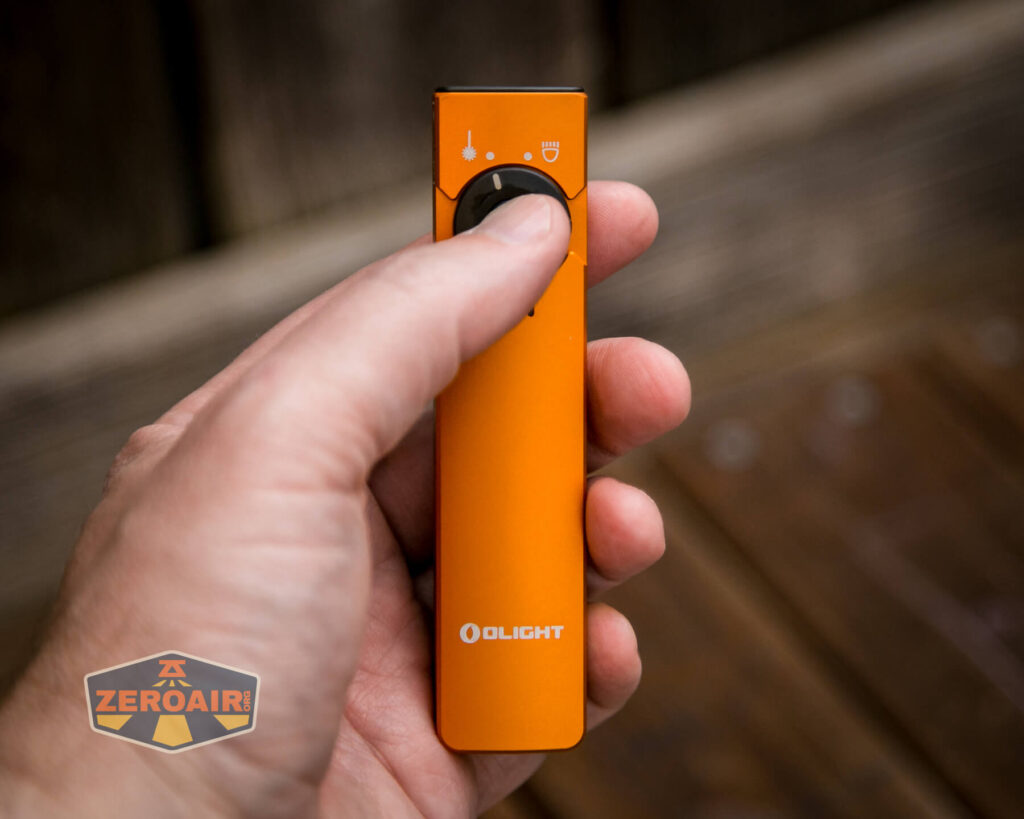 Olight Arkfeld flashlight laser combo in hand