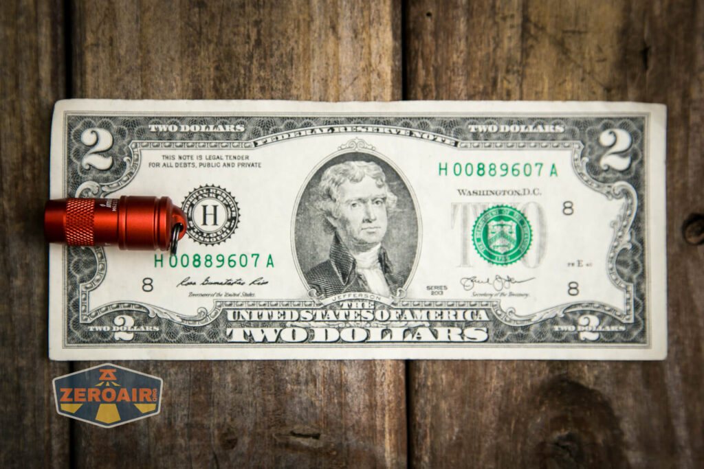 Olight iMini Keychain flashlight on two dollar bill
