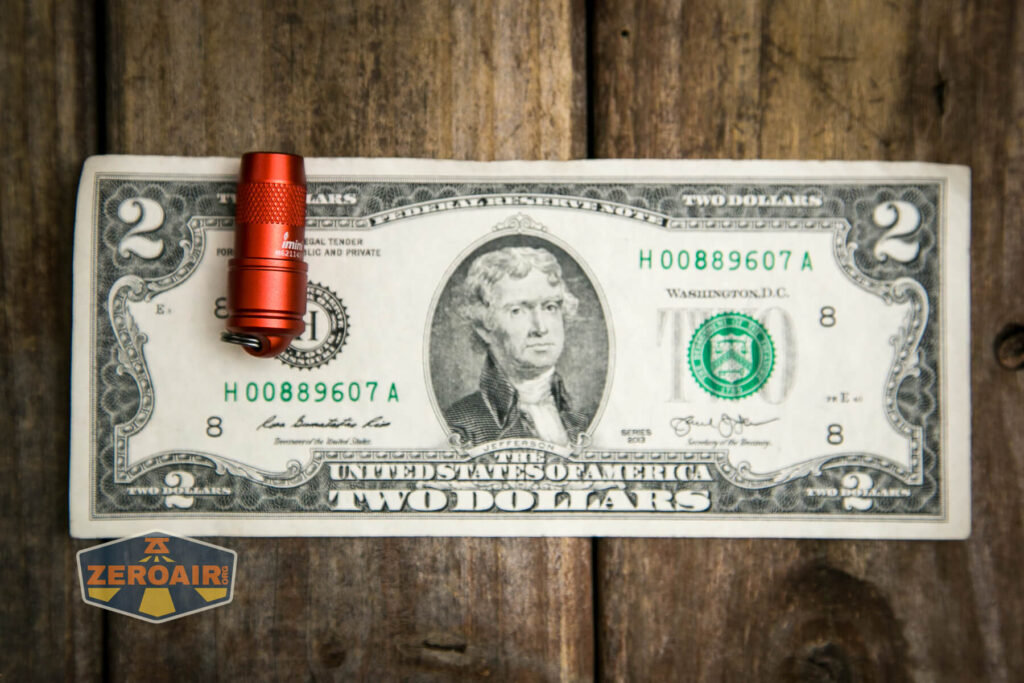 Olight iMini Keychain flashlight on two dollar bill