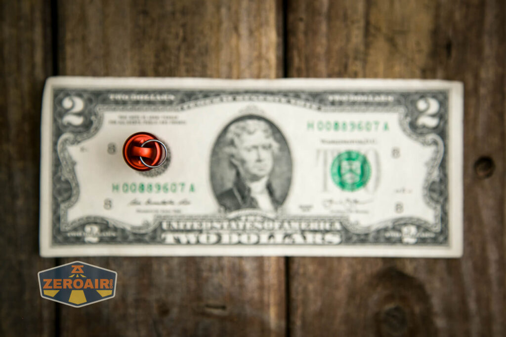 Olight iMini Keychain flashlight on two dollar bill