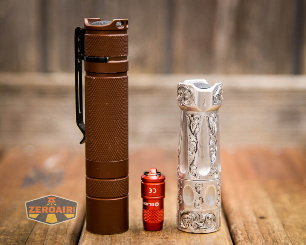 Olight iMini Keychain flashlight beside lights