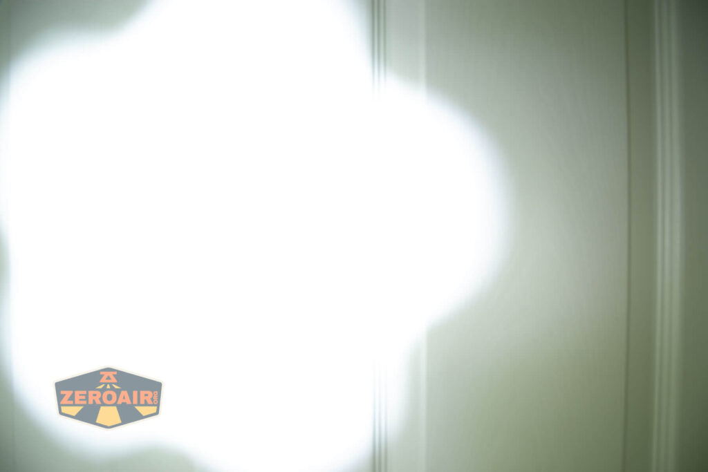 Thrunite BSS V5 flashlight beamshots on door compared to nichia 219b