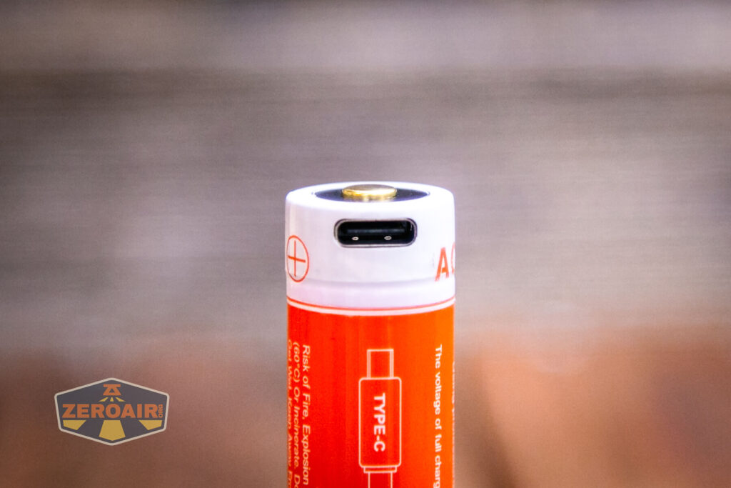 Acebeam E70 Mini Titanium flashlight charging on cell